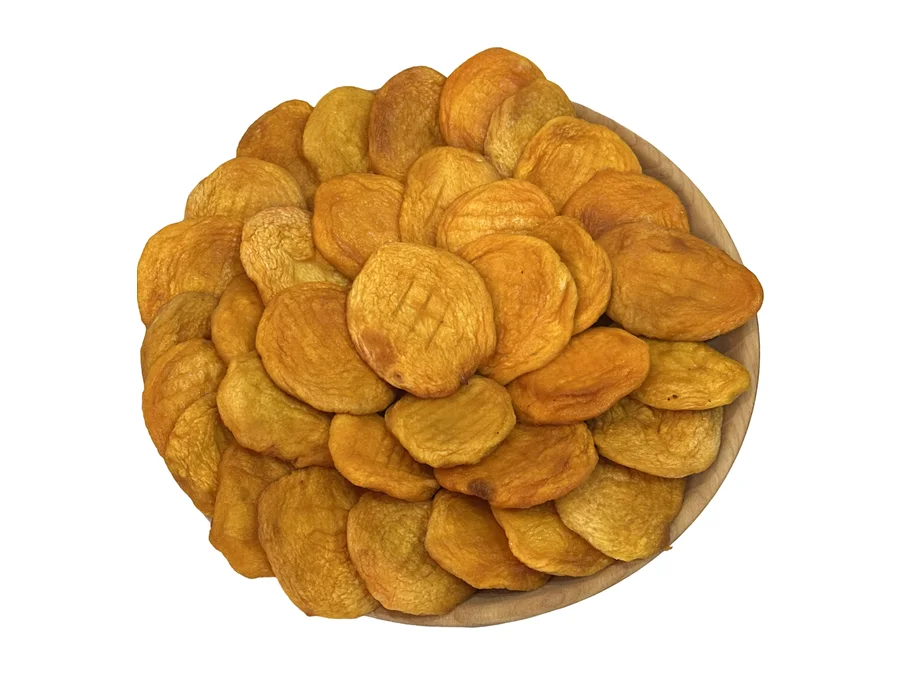 Armenian dried peach halves heaped in a round wooden bowl, deep gold to amber, seen from directly above