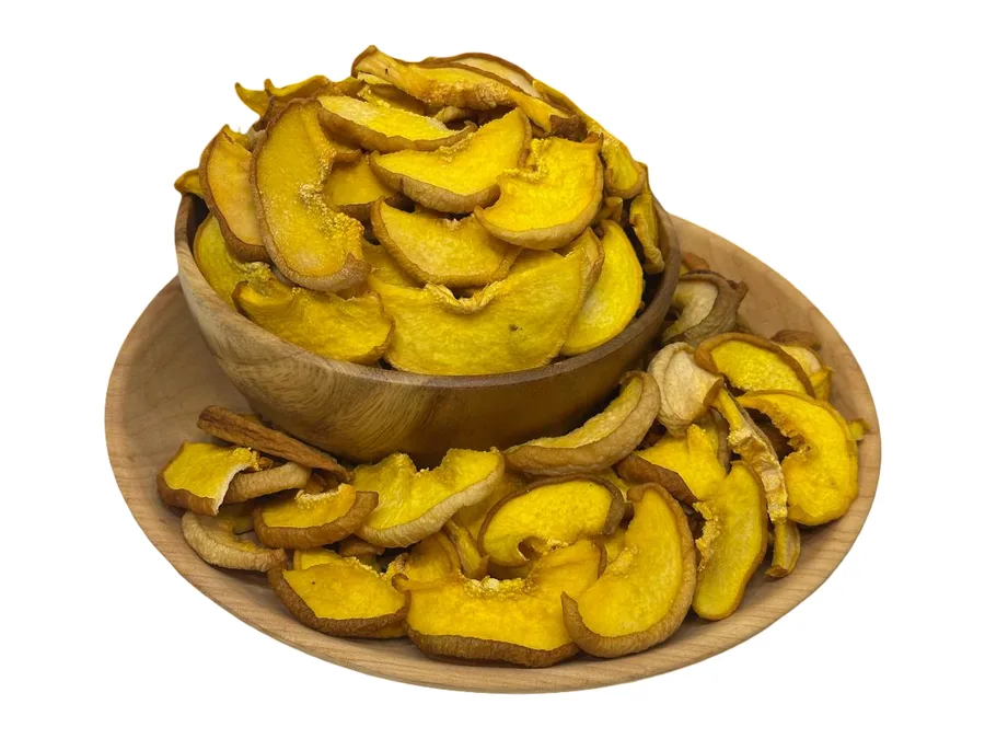 A wooden bowl heaped with Armenian dried quince slices, deep golden, seen at an angle